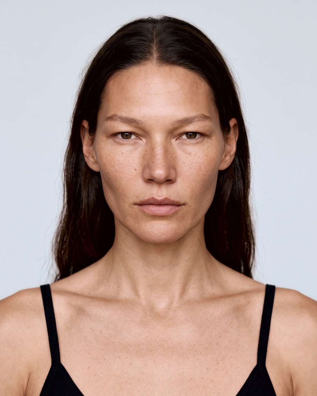 Model portrait, center part, black camisole